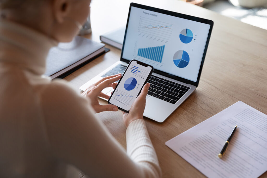 Reviewing charts on laptop and phone