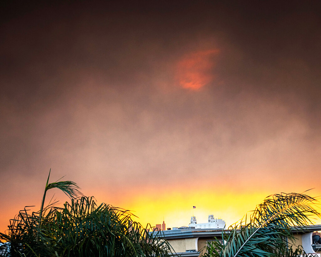 Smoke from the January 2025 wildfires light up the sunrise over downtown Los Angeles, CA.